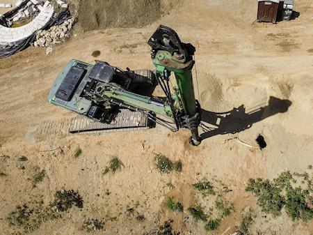 TROYCO using a drill rig to dig a hole for concrete piles.